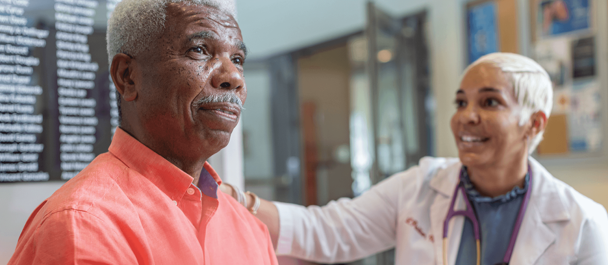 Health worker speaking to an older patient.